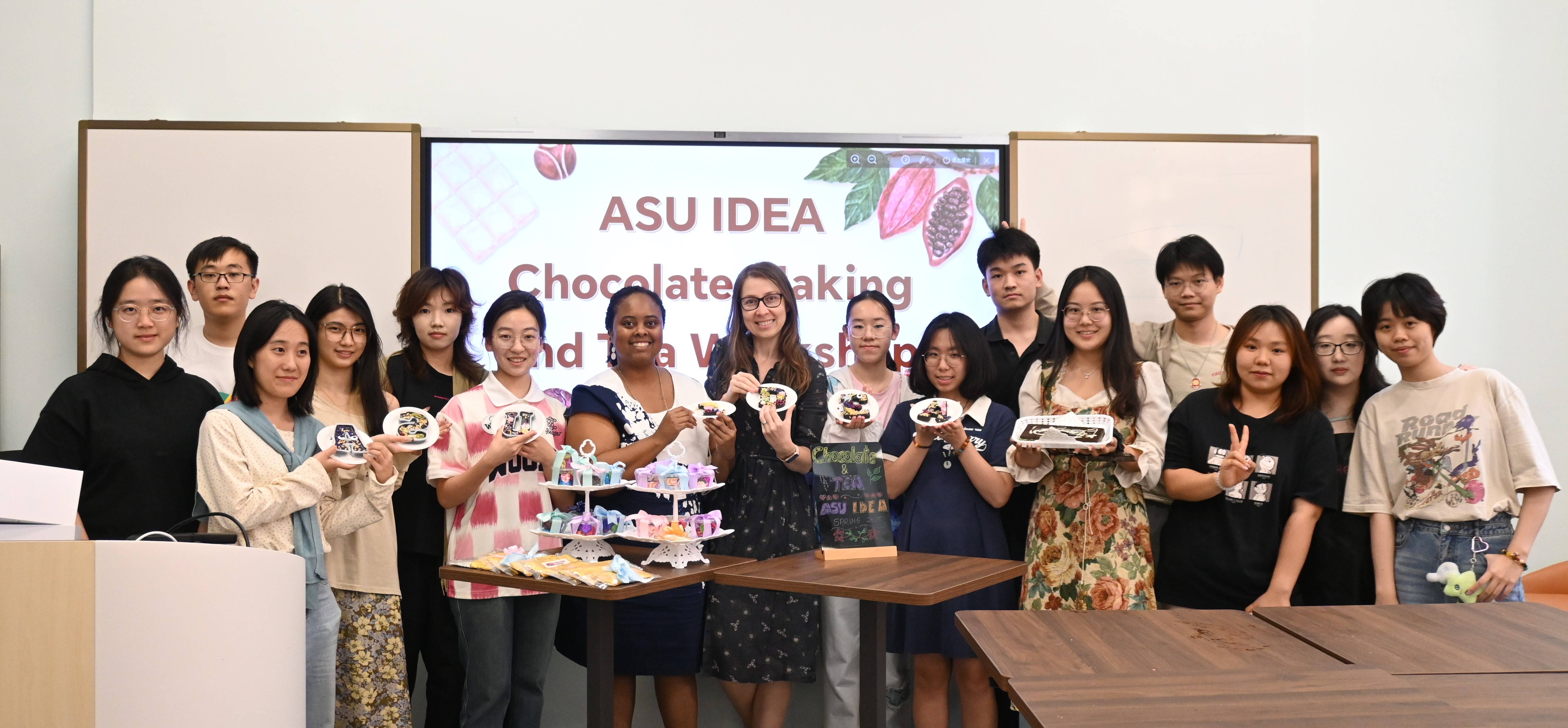 Group picture of HAIC students holding up chocolate and tea